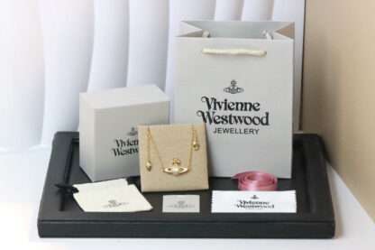 Vivienne Westwood gold-rimmed white enamel shooting star Saturn necklace - Image 3