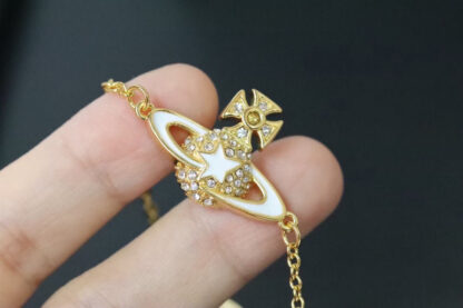 Vivienne Westwood gold-rimmed white enamel shooting star Saturn necklace - Image 5